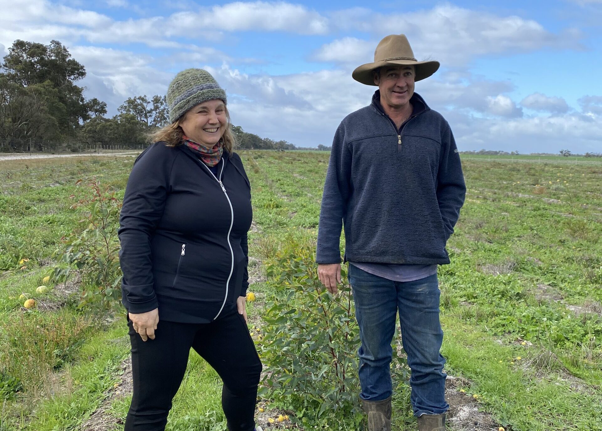 Woman and man standing next to each other in planting area