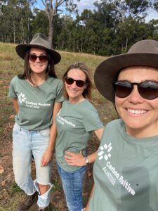 Three team members taking a selfie at the Tootanellup project site wearing new carbon positive Australia shirts