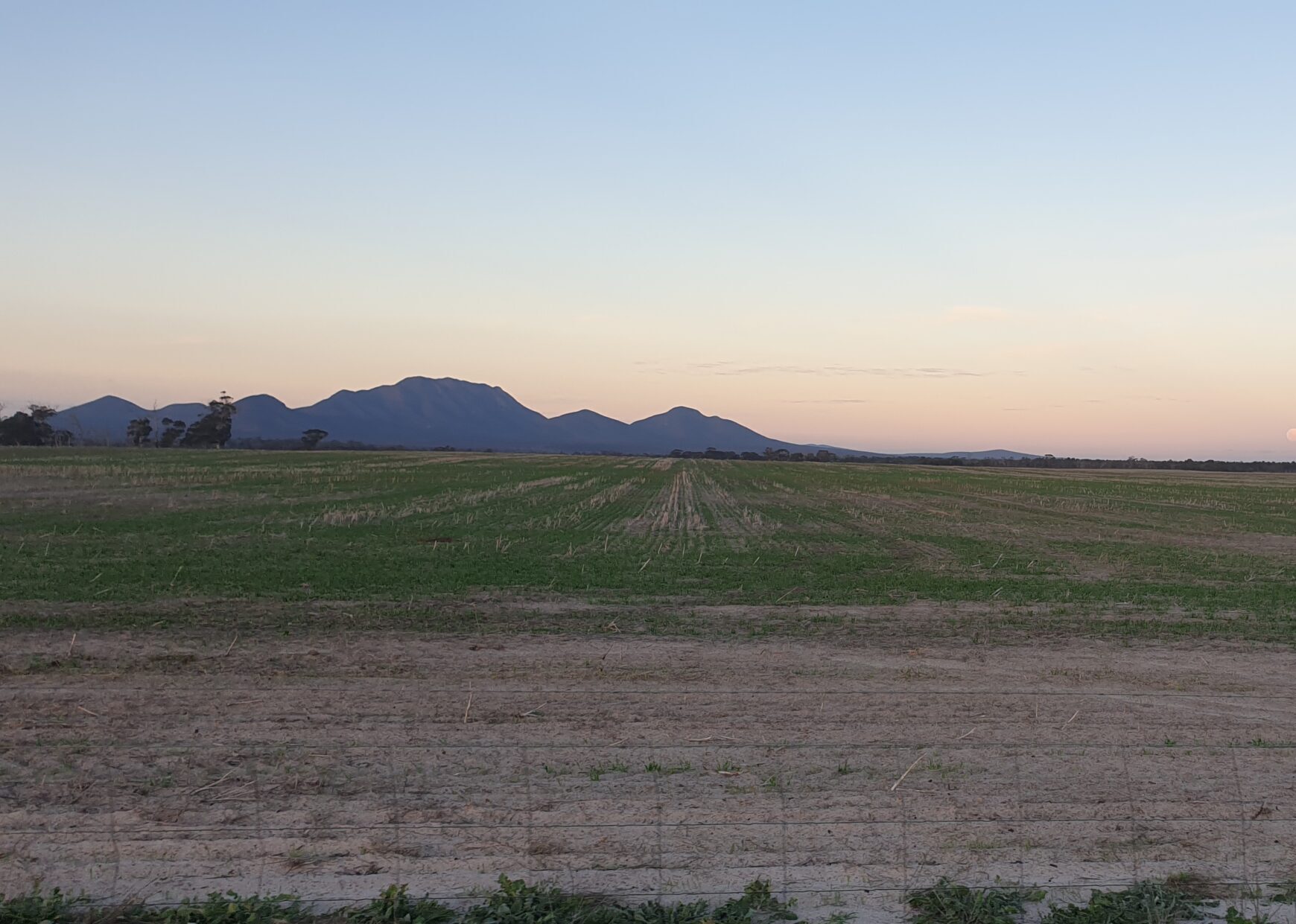 Landscape at sunset with rolling mountains in the background