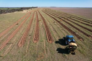 Drone photo of tree planting project with tractor in the foreground