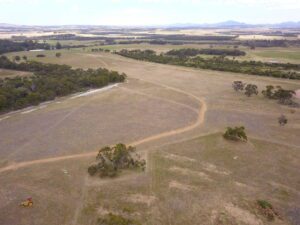 Drone photo of agricultural land with some remnant trees