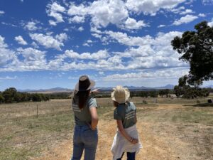 Two women pointing and admiring the view of the Stirling Ranges from the the planting site.