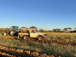 White ute and tractor on paddock
