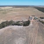 High angled drone shot of cleared planting area with pockets of remnant vegetation