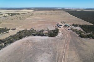 High angled drone shot of cleared planting area with pockets of remnant vegetation