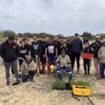 Group photo with planting equipment