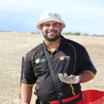 Man smiling with seedling bucket