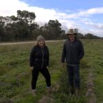 Woman and man standing next to each other in planting area