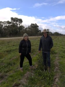 Woman and man standing next to each other in planting area