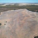 High angled drone shot of cleared planting area with pockets of remnant vegetation