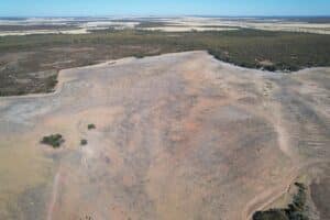 High angled drone shot of cleared planting area with pockets of remnant vegetation