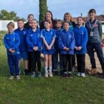 Group photo of adults and children in school uniform