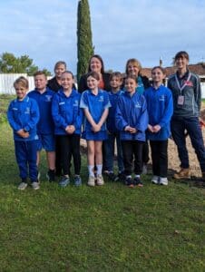 Group photo of adults and children in school uniform