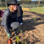 Women crouching with seedlings 