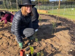 Women crouching with seedlings 