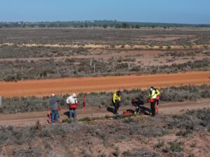 Group of men refilling their seedling buckets.